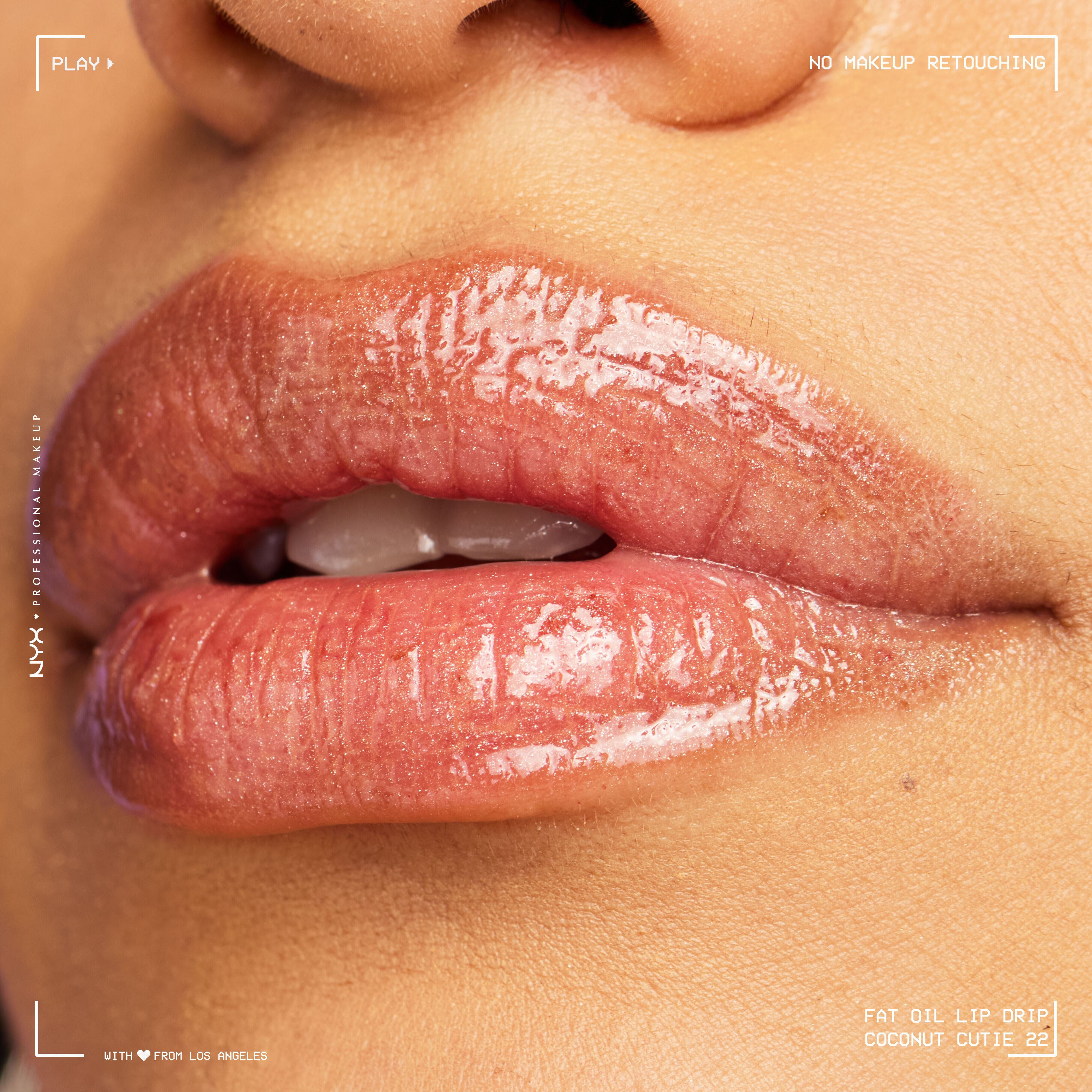 Close-up of model with medium skin tone wearing Fat Oil Lip Drip in Coconut Cutie, showing hydrated shine and natural texture.