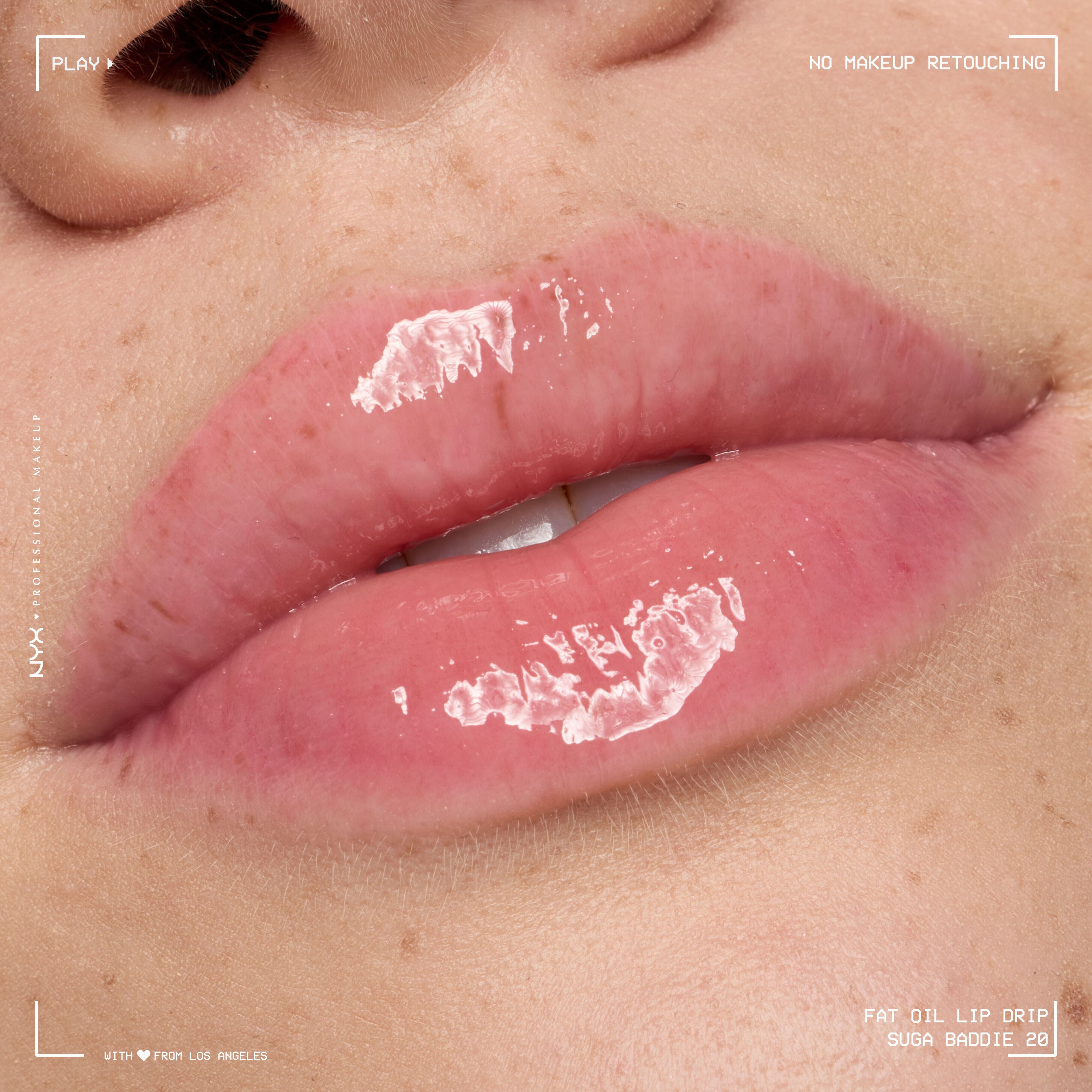Close-up of model with fair skin tone and freckles wearing Fat Oil Lip Drip in Suga Baddie, showing pink tint, smooth texture, and high-shine finish.