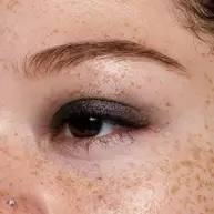 Close-up of an eye wearing NYX Professional Makeup Party Animals Lid Lingerie Cream Eye Pigment in Pumpkin Vice, a deep metallic orange shade.