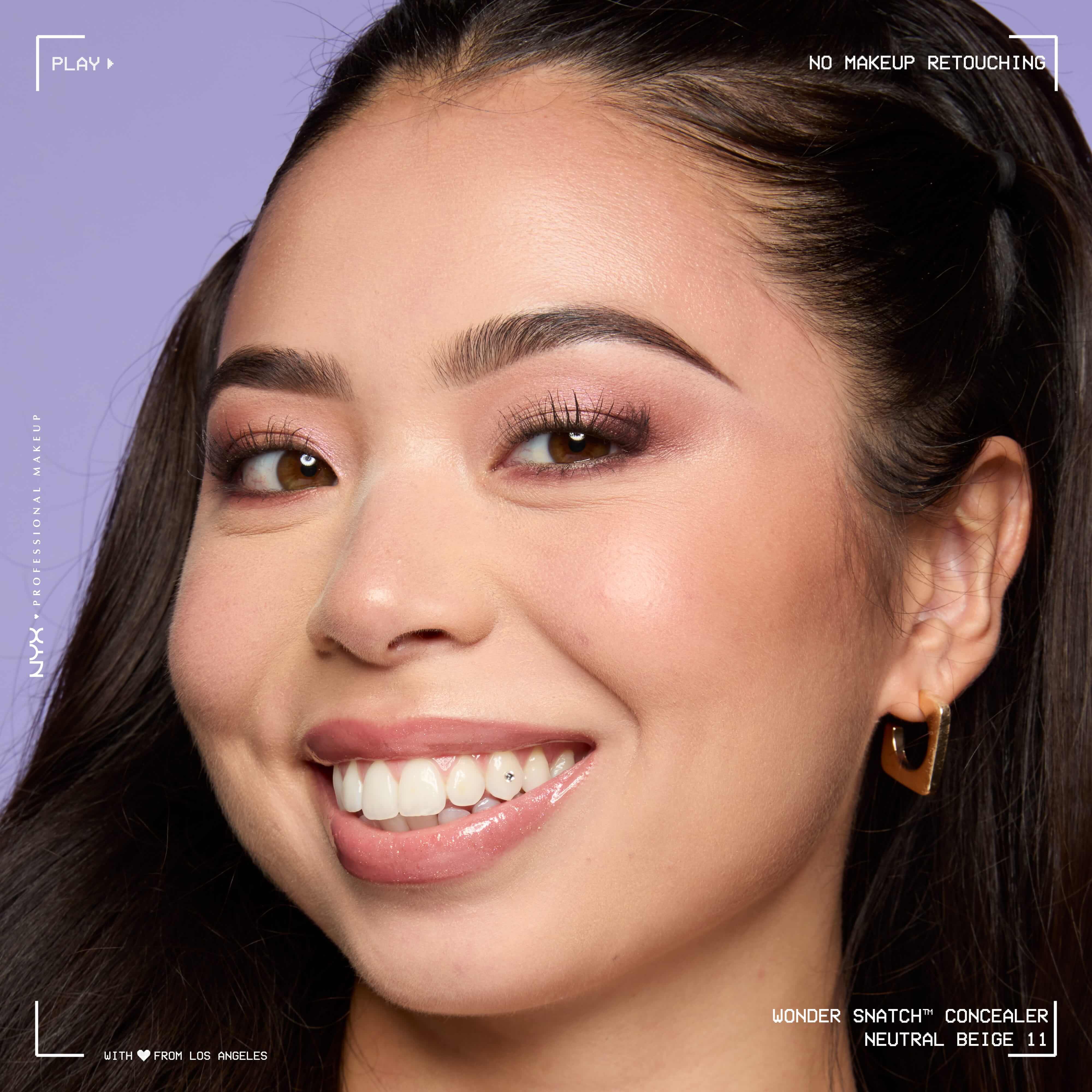 Close-up of model wearing Wonder Snatch(TM) Concealer, with brightened under-eyes, smooth-looking skin, and a natural finish.