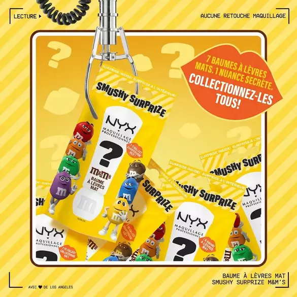 NYX Professional Makeup M&M’S Smushy Surprize Matte Lip Balm packaging in a claw machine setting, surrounded by colorful M&M’S characters and a callout promoting 7 collectible lip balms, 1 rare. Yellow striped background.